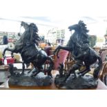 A pair of late Victorian black painted spelter Marli horses with attendants,