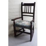 A doll's late 19thC stained beech and mahogany rocking chair with a floral patterned fabric covered