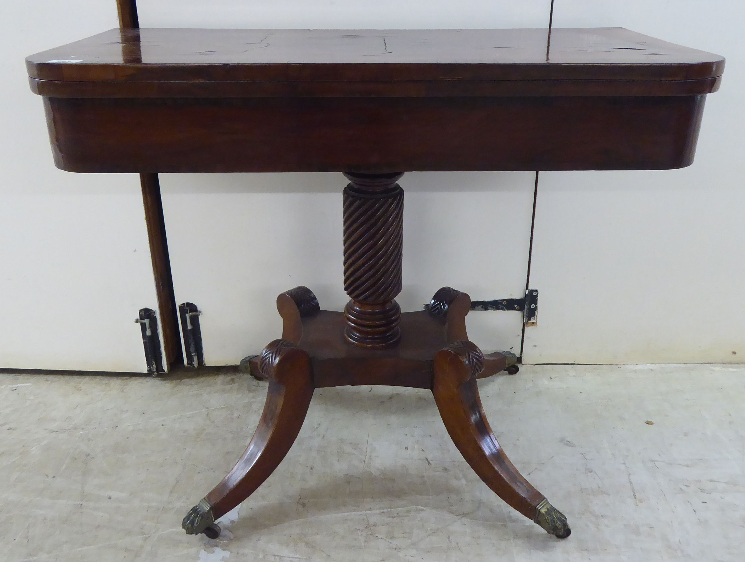 A Regency crossbanded, rosewood and mahogany card table with a foldover top,
