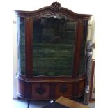 A late 19thC Continental mahogany display cabinet with a carved crest,