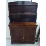 An early Victorian mahogany chiffonier with a shelved superstructure, over a pair of panelled doors,