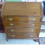 An early 20thC mahogany bureau, the fall flap over four graduated drawers,