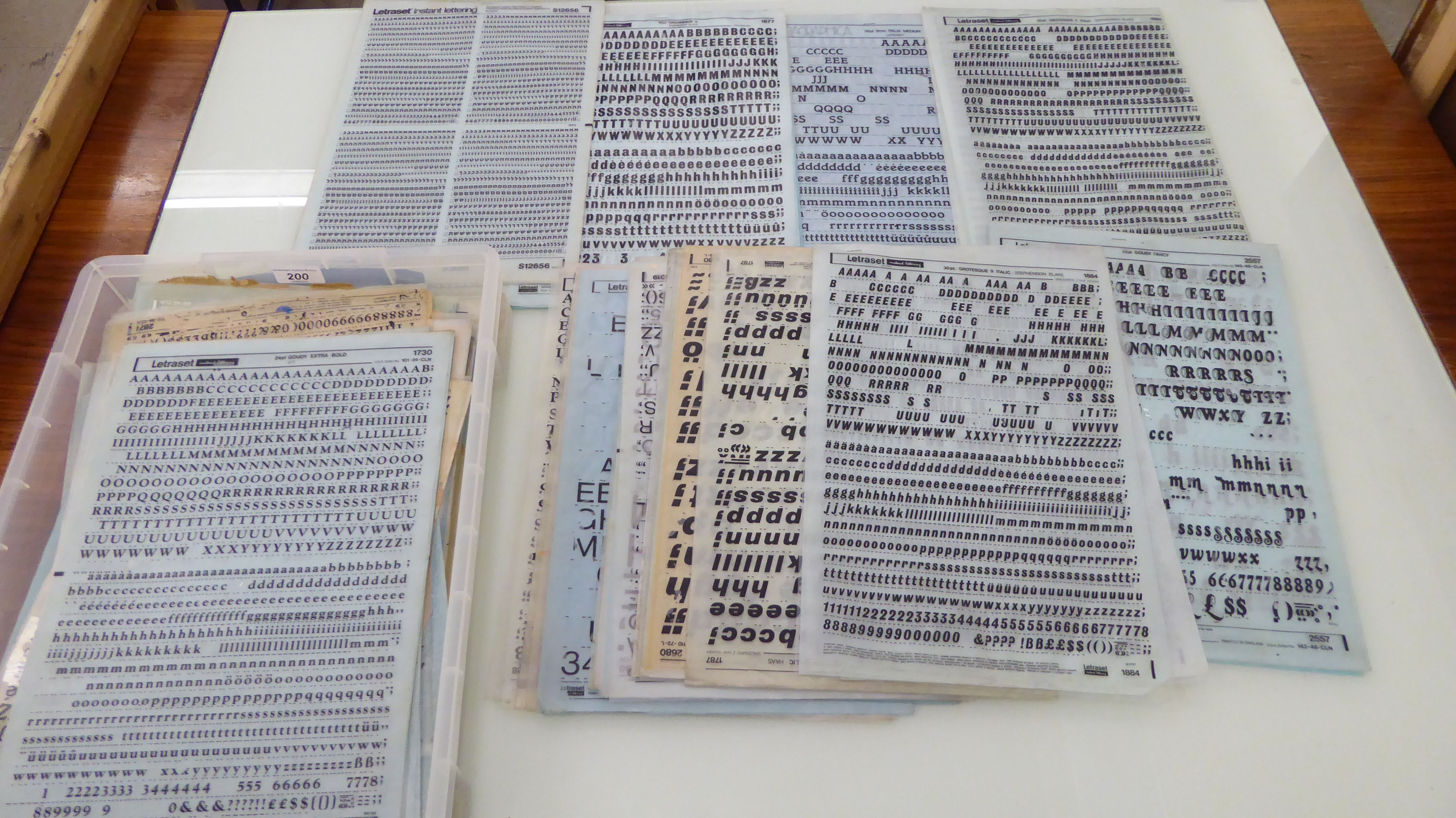 An uncollated collection of Letraset transfers, comprising Arabic numerals and alphabet letters,