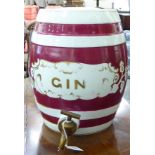 A late 19thC puce coloured and gilded china bar room gin barrel with a gilt metal tap 13''h