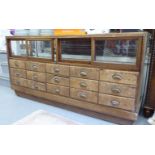 An early 20thC haberdasher's fully glazed and brass framed display counter,