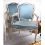 A pair of mid 20thC Louis XV design cream painted salon chairs with a blue fabric upholstered back