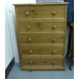 A modern honey coloured pine, five drawer tallboy,