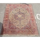 A Persian part silk rug, decorated with dense flora,