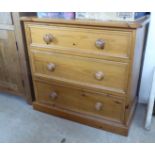 A modern honey coloured pine, three drawer dressing chest, on a plinth 27''h 29.