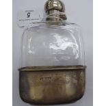 A clear shouldered glass, hip flask with a silver collar, a rotating, outset, hinged,