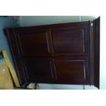 An early 20thC Continental mahogany wardrobe with a level cornice,