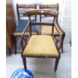 A Regency rosewood framed open arm chair, raised on turned, reeded,