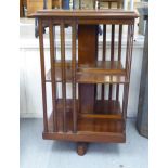 A Victorian mahogany two tier, revolving bookcase with slatted sides,