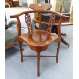 A modern Indo-Chinese teak framed corner chair with a level back and low crest,