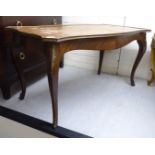 An early 20thC kingwood and marquetry coffee table, the top on an applied gilt edge,