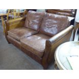 A modern bergere style, mahogany framed two person settee with double caned, level,