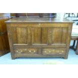 A late 18thC tri-panelled oak dower chest with straight sides and a planked, hinged lid,