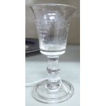 A late 18th/early 19thC wine glass, the bucket shaped bowl having a flared rim,