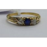 An 18ct gold diamond and sapphire three stone ring 11