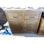 A modern pine dresser with two drawers, over a pair of doors,