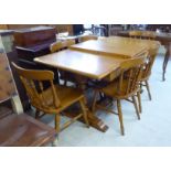 A Stewart Linford light oak dining table, the two part top with round corners,