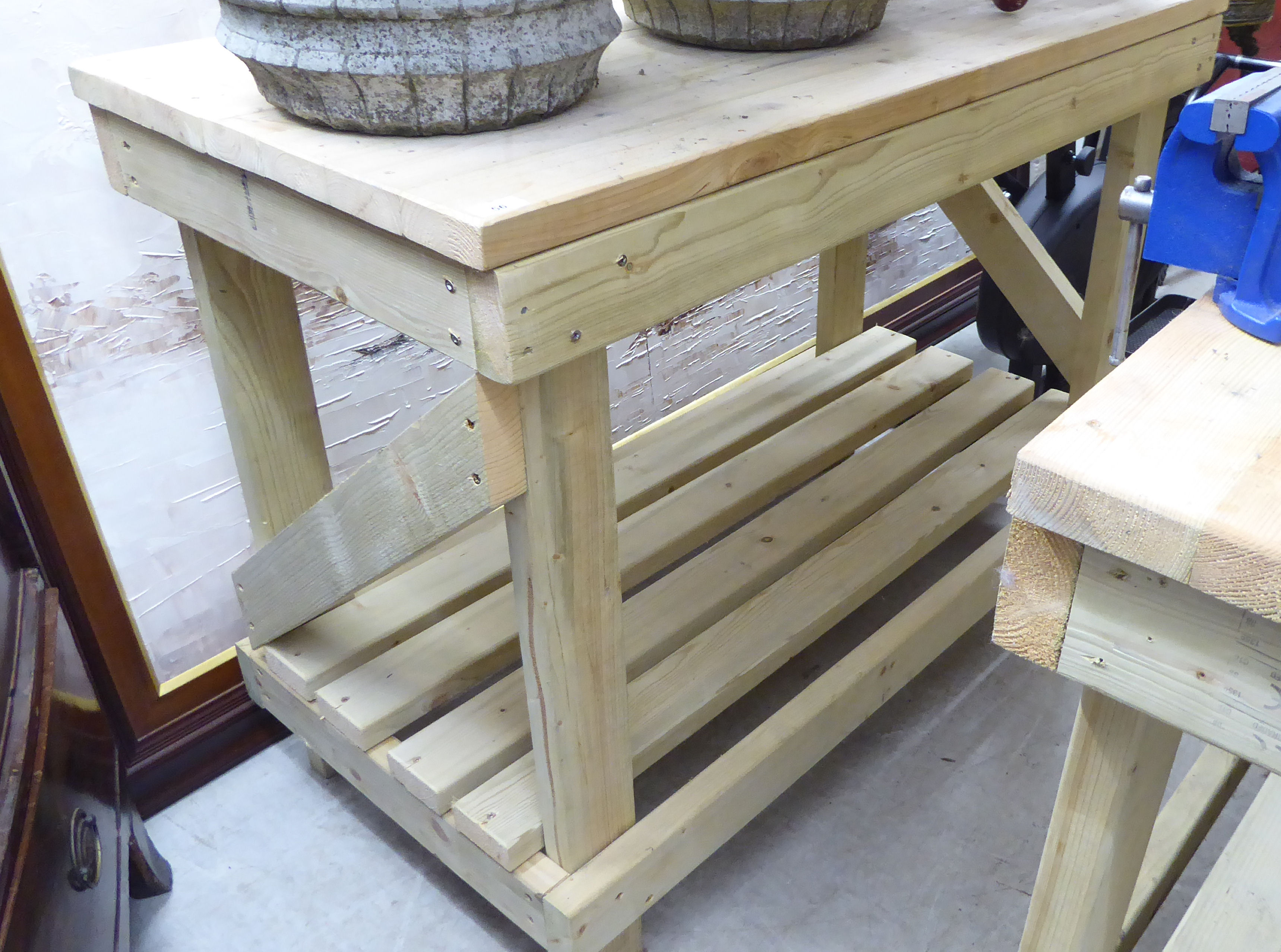 A modern pine two tier workbench of planked and slatted construction,