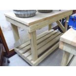 A modern pine two tier workbench of planked and slatted construction,
