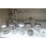 A varied collection of 19th and early 20thC glass dressing table and vanity case jars,