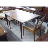 An early 1970s McIntosh teak dining table, the top with a thumb moulded edge, raised on square,