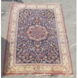 A Persian part silk rug, decorated with dense flora,