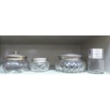 Three similar cut glass powder bowls with silver covers; and a drum design dressing table jar,