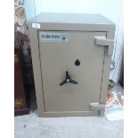 A modern Dudley Safes old gold coloured enamelled steel office safe with a rotating handle and key