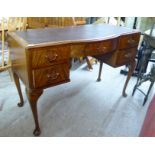 A modern mahogany finished bow front five drawer kneehole desk,