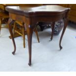 A late 19thC Continental oak tea table with a bow front and foldover top,