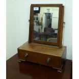 An early 20thC mahogany framed toilet mirror, the rectangular plate pivoting on angled horns,