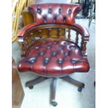 A modern mahogany framed captain's style desk chair,