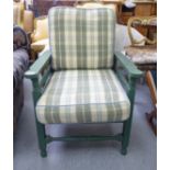 An early 20thC green painted wooden reclining arm chair,