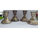 Two similar pairs of loaded silver dwarf candlesticks with integral vase shaped sockets mixed