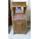 A late 19thC Continental walnut bedside cabinet, the top surmounted by a shelf,