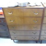 A 1970s teak finished five drawer dressing chest, raised on square,