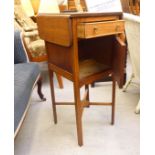 An early 20thC mahogany bedside table, the top with shallow fall flaps, over a drawer and a door,
