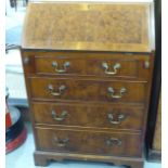 A modern yewwood finished lady's bureau, the fall front enclosing a fitted interior,