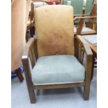 An Art Deco stained oak framed fireside chair, the hide covered back and cushioned seat,
