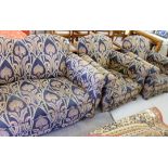 A 1930s three piece suite upholstered in an Art Nouveau fabric, raised on turned bun feet,