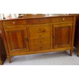 A modern French mahogany finished sideboard, comprising five central drawers, flanked by a drawer,