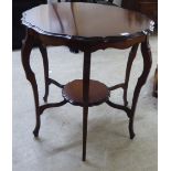 An Edwardian mahogany hall table, the top with a moulded piecrust border, raised on serpentine legs,