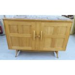 An Ercol pale coloured elm and beech sideboard, the top with round corners,