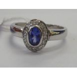 A white coloured gold ring stamped 18ct, set with tanzanite,