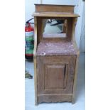 A late 19thC Continental walnut bedside cabinet, the top surmounted by a shelf,