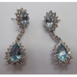 A pair of white coloured gold claw set aquamarine and diamond drop earrings 11